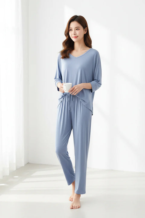 Light blue pajama set on hangers against a white background